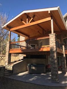 a large house with a covered patio and hot tub