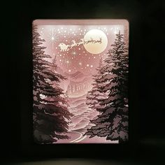 a lit up box with a christmas scene on it