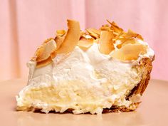 a piece of pie with white frosting and almonds on top