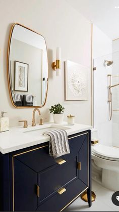 a bathroom with a sink, mirror and toilet in it's centerpieces