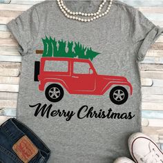 a gray shirt with a red truck and christmas tree on the back that says merry christmas