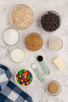 the ingredients to make an ice cream sundae laid out on a marble counter top