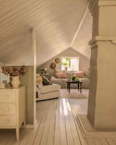 a living room filled with furniture next to a wooden floor covered in lots of white paint