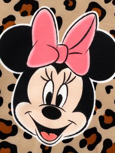 a minnie mouse face with a pink bow on it's head and leopard print background