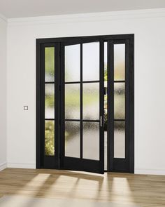 an empty room with two black doors and windows on the wall, in front of a wooden floor