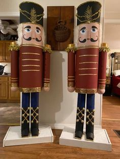 two wooden nutcrackers standing next to each other