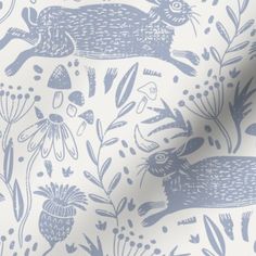 a blue and white wallpaper with rabbits on it