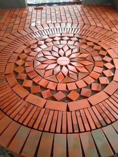 a circular design made out of bricks on the ground