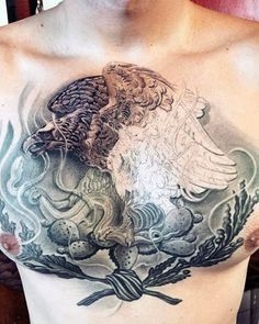 a man's chest with an eagle and fish tattoo on it