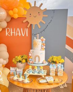 a table topped with a cake next to balloons and other items on top of it