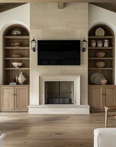 a living room filled with furniture and a flat screen tv mounted on a wall above a fireplace