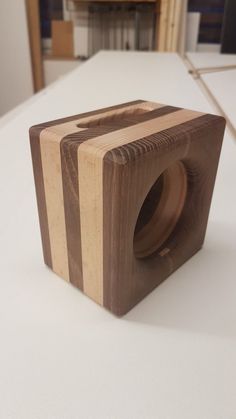 a wooden object sitting on top of a white table