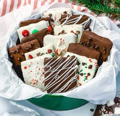 a bowl filled with lots of different types of chocolates and marshmallows