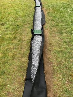 a large pipe laying on top of a grass covered field