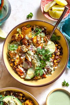 two bowls filled with food next to drinks