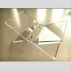 a glass sculpture is on the wall in front of a mirror that looks like it has been broken