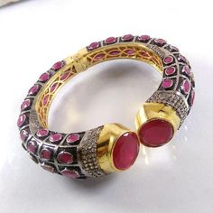 This Listing is for 1 Piece Beautiful Red Aventurine & CZ Hydro Gemstone Gold Plated Cuff Bangle Bracelet Jewelry Gemstone: Red Aventurine & CZ Metal : Brass  Style : Cuff Bracelet  Size : Cuff Adjustable Size Plating : Gold Plated & Black Oxidize  Color : Yellow,White, Black  Note : We Ship Parcel Via India Post Economy Shipping It's Take 20 To 25 Days To Arrive. Check my other items frequently. I will be adding to the inventory regularly. Be sure to visit my shop to check for any coupon codes Red Bangle Jewelry With Jewels, Unique Jeweled Bangle Bracelets, Red Jeweled Bangle For Gift, Red Jeweled Bangle As A Gift, Red Jeweled Bracelets As Gift, Jeweled Crystal Bangle Bracelet, Red Jeweled Bracelets For Gift, Jeweled Round Crystal Bracelet As Gift, Jeweled Crystal Bracelet Gift