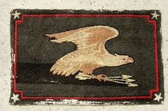 an eagle rug on the ground with stars around it and a red border in the middle