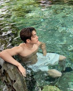 a young man is floating in the water