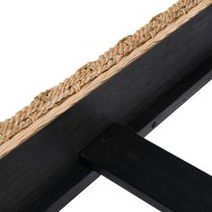 a close up of a wooden frame with rope on it