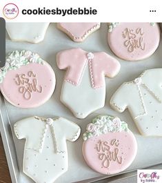 decorated cookies in the shape of baby clothes