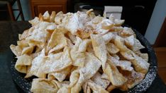 a black bowl filled with chips on top of a table