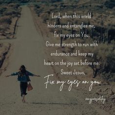 a woman walking down a dirt road with her arms spread out in front of her