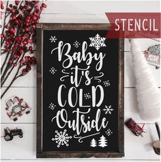 a black and white sign that says baby it's cold outside with snowflakes