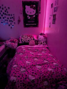 a bedroom with hello kitty bedding and pink lighting