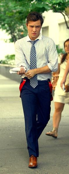 a man walking down the street wearing a tie