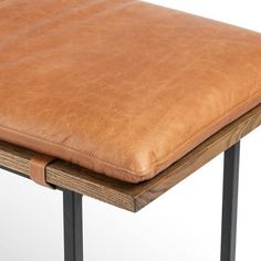 a brown leather seat on top of a wooden table