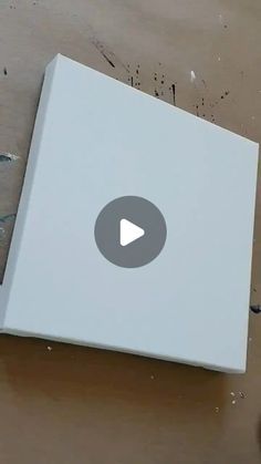 an open white box sitting on top of a wooden table next to a pair of scissors