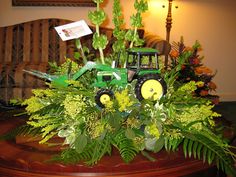 an arrangement of flowers and plants on a table