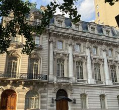 the building has many windows and balconies on it's sides, along with an ornate balcony