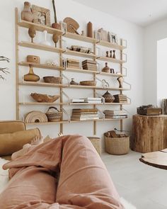 a living room filled with furniture and shelves