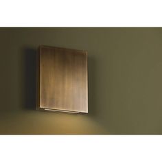 a wall light mounted on the side of a green wall