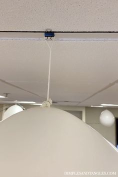 a suspended light fixture in an office building