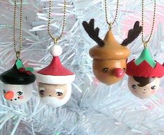 three christmas ornaments hanging from a tree with snowflakes and reindeer hats on them