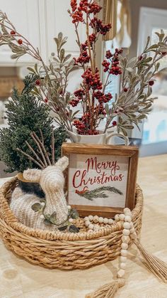 a basket filled with christmas decorations sitting on top of a table next to a sign