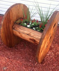 a wooden planter with flowers in it