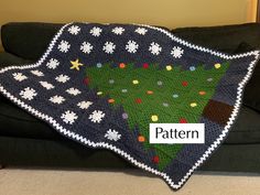 a crocheted christmas tree blanket on a couch with the word pattern written across it