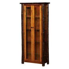 a tall wooden cabinet sitting on top of a hard wood floor next to a wall