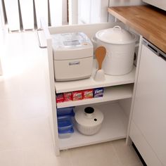 a small kitchen with white appliances and wood counter tops