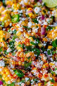 corn salad with cilantro, red onion, and feta cheese on top