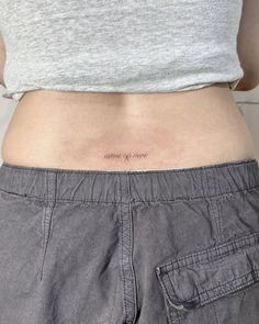 a woman with a small tattoo on her stomach