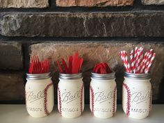 three mason jars with red and white striped straws in them