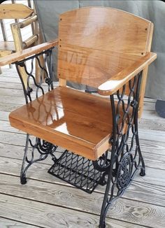 two wooden chairs sitting next to each other on a wooden floor with metal frame legs