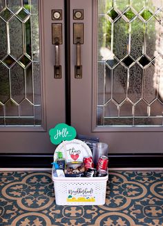 the front door is decorated with an assortment of snacks and drinks, along with a welcome sign