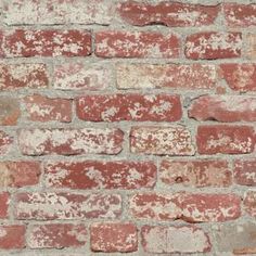 an old brick wall that is red and white with some brown spots on the bricks