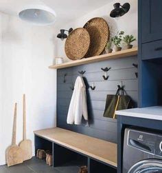 an instagram photo of a washer and dryer in a room with blue cabinets